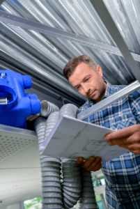 Technician reading AC plans