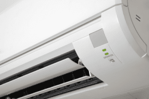 AC unit mounted on wall with green light indicator